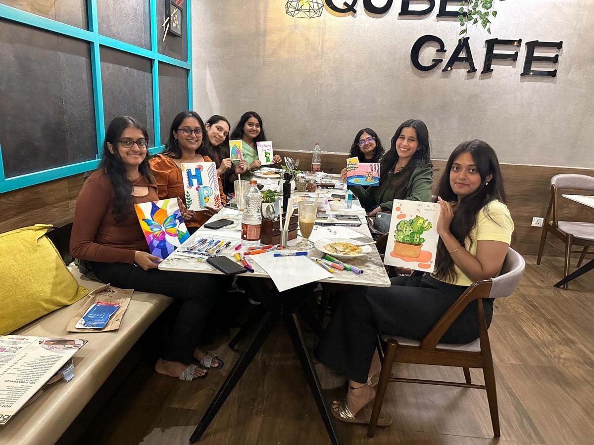 go girl! community members painting and crafting together at a cafe meetup