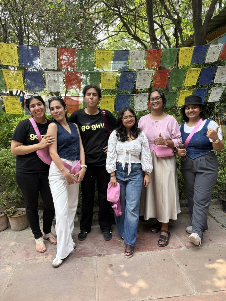 go girl! community members posing together outdoors