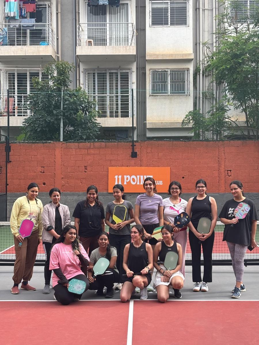 go girl! community members playing pickleball together