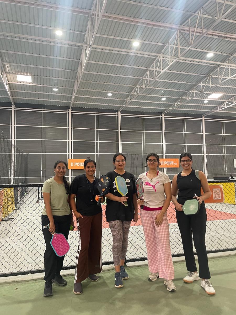 go girl! community members playing pickleball together