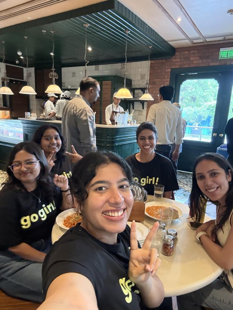 go girl! community members at a restaurant meetup, all wearing go girl! t-shirts