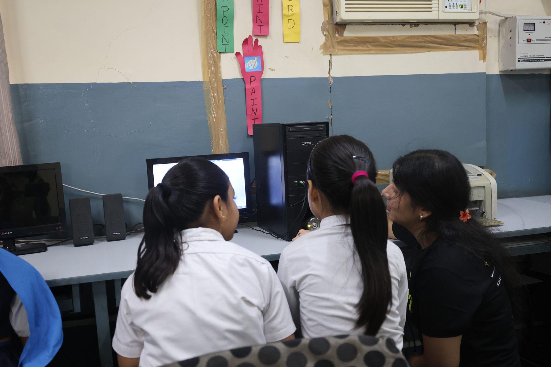 Girls working at computers in a Go Girl coding class