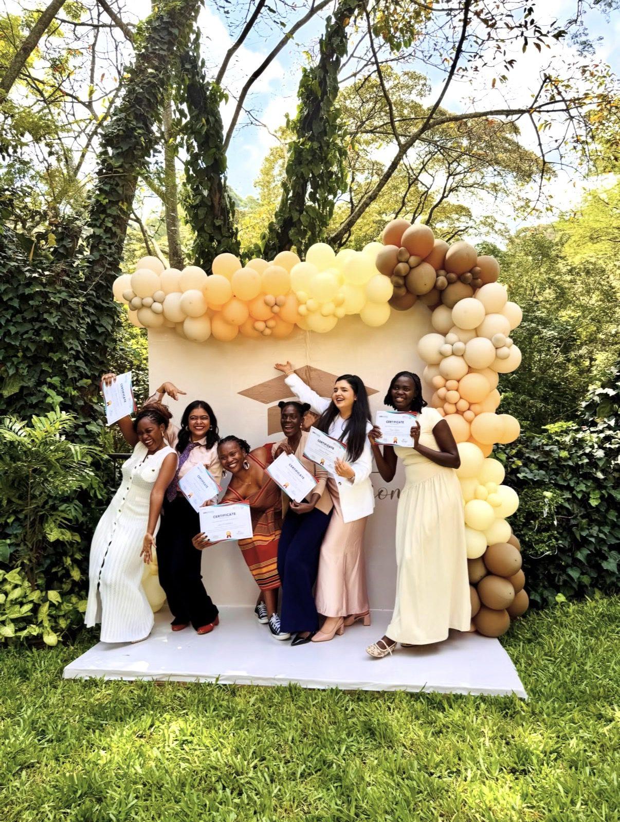Shaniya from Go Girl celebrating with the She's the First cohort in Nairobi, everyone holding certificates